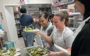 Students serving salad