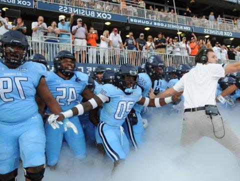 ODU football players run through the tunnel at the beginning of a football game